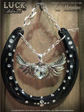 LOVE ROCKS Luck Adorned Lucky Horseshoe is a glossy black horseshoe with a big, chunky, silver heart in the center, accented with white diamond Swarovski crystals, all hanging from funky silver chain.