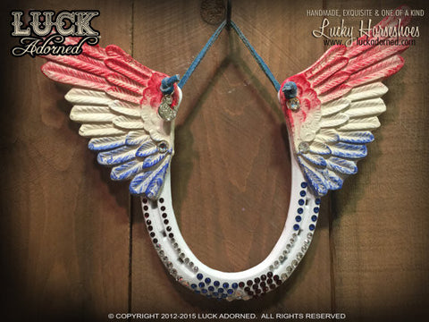 PATRIOT Luck Adorned Lucky Horseshoe is a glossy white horseshoe with wings hand painted in all American style, Red, White & Blue. 