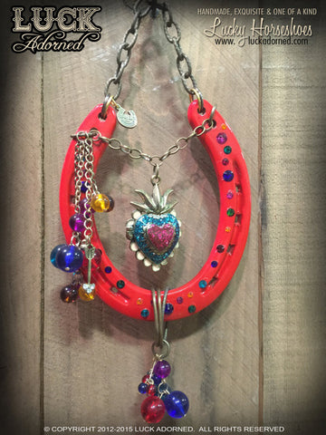 SACRED RIO Luck Adorned lucky Horseshoe is a striking red horseshoe that just screams fun & festive! It has a gem of a centerpiece that is actually a sacred heart photo locket.